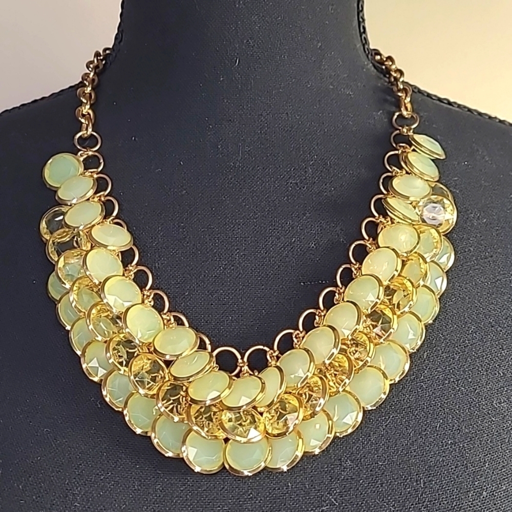 Gold tone necklace with clear and light green translucent beads. 23 inches"